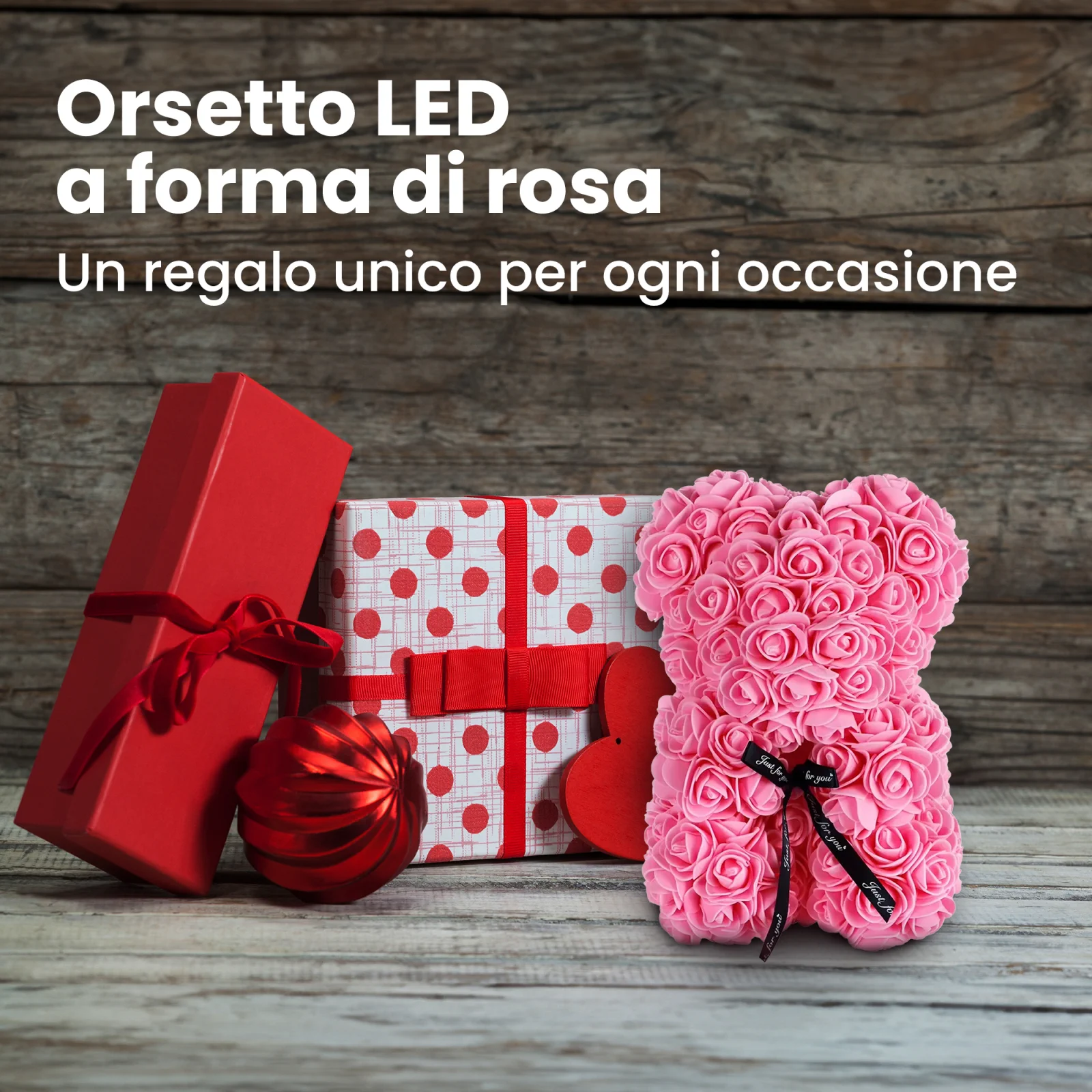 l'orsacchiotto rosa si trova accanto a due confezioni regalo e a un gingillo