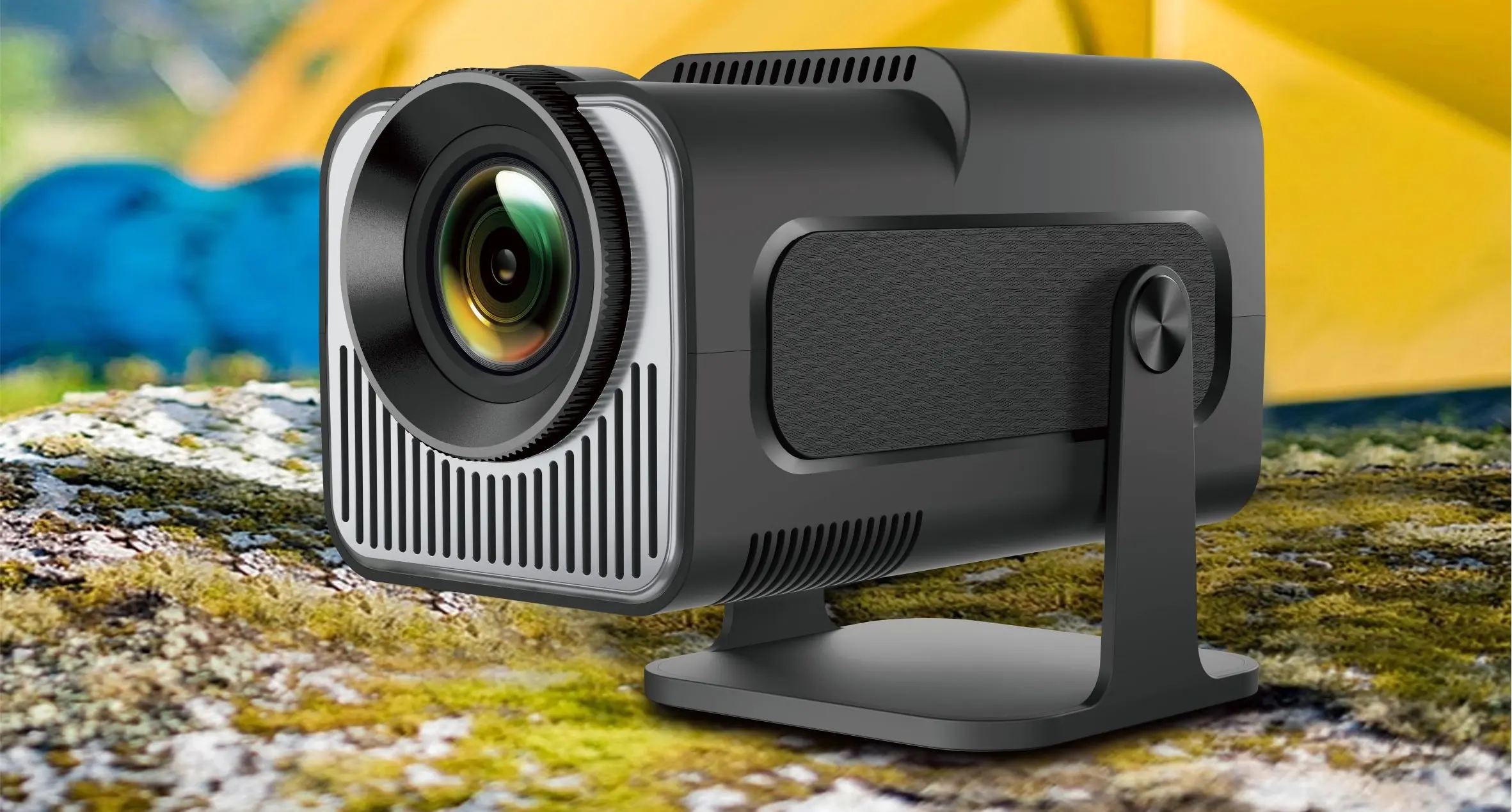 Extralink GG400X projector set up outdoors, with a backdrop of a tent and nature, showing its compact design