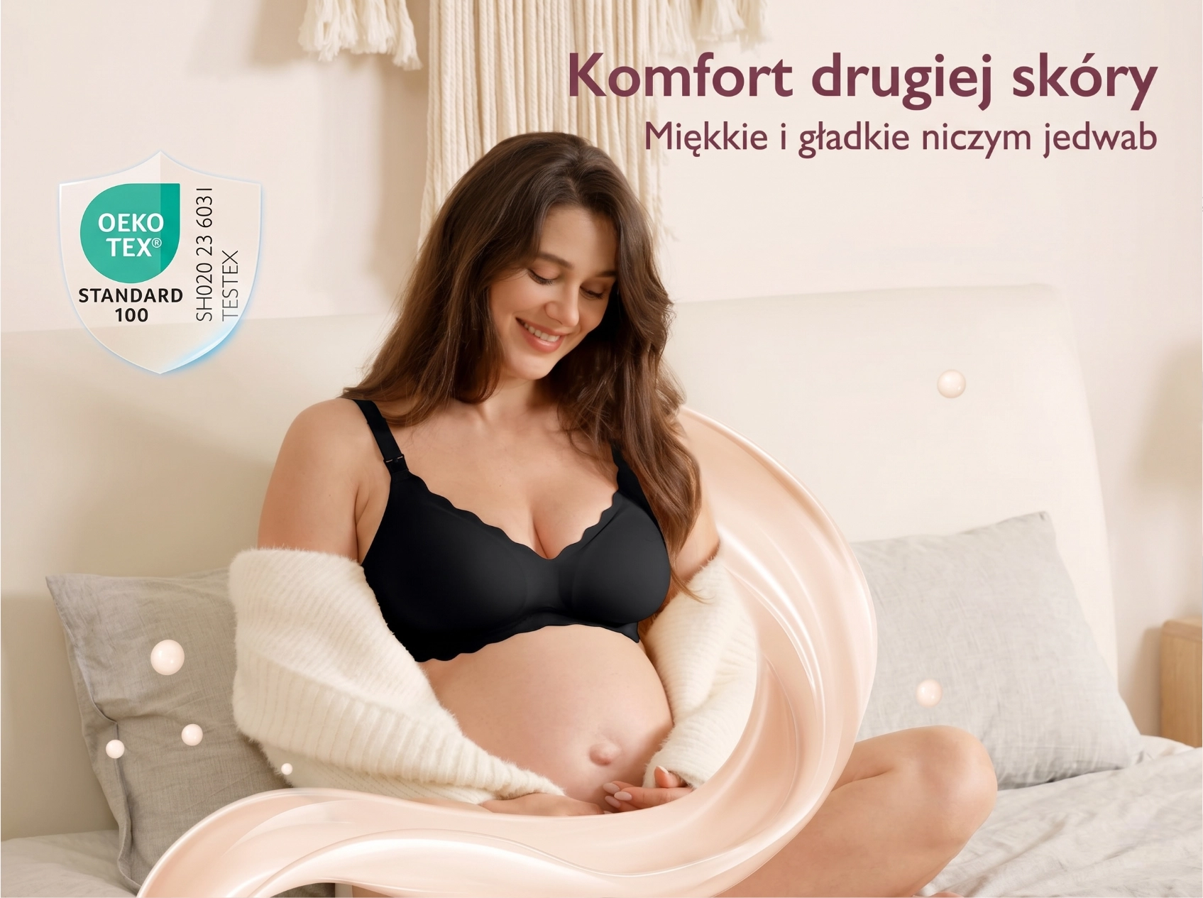 Mulher grávida com sutiã preto sentada na cama, com visualização de tecido macio e selo OEKO-TEX ao redor