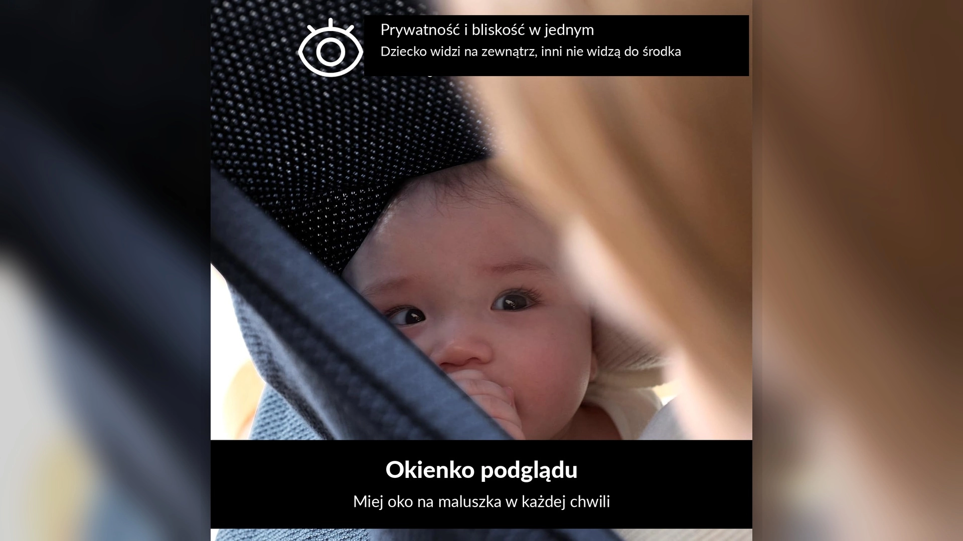 Twarz niemowlęcia widoczna przez uchyloną granatową osłonę Momcozy
