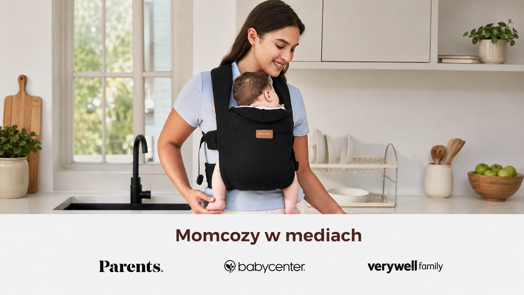 Ergonomic Momcozy CB002 WeeSnug Newborn Carrier Cotton Black carrier. Mother with child in the kitchen and media logos.