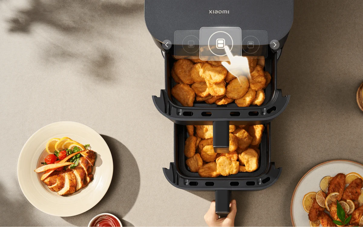 Top view of the Xiaomi air fryer with two drawers pulled out, full of nuggets, and plates with chicken and dip