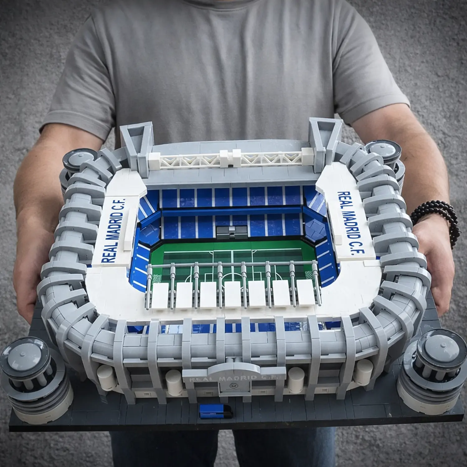 Model stadionu s viditelnými tribunami a hřištěm.