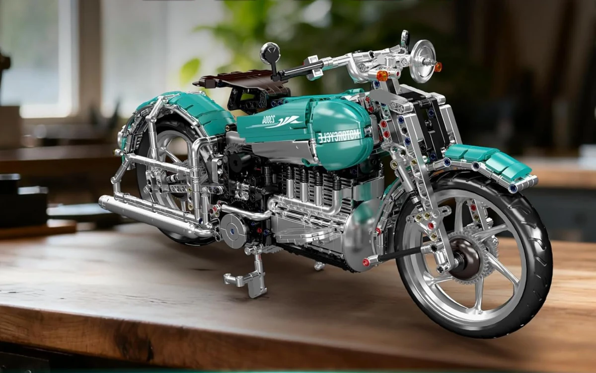 Turquoise and silver motorcycle made from construction blocks displayed on a wooden workbench in a workshop