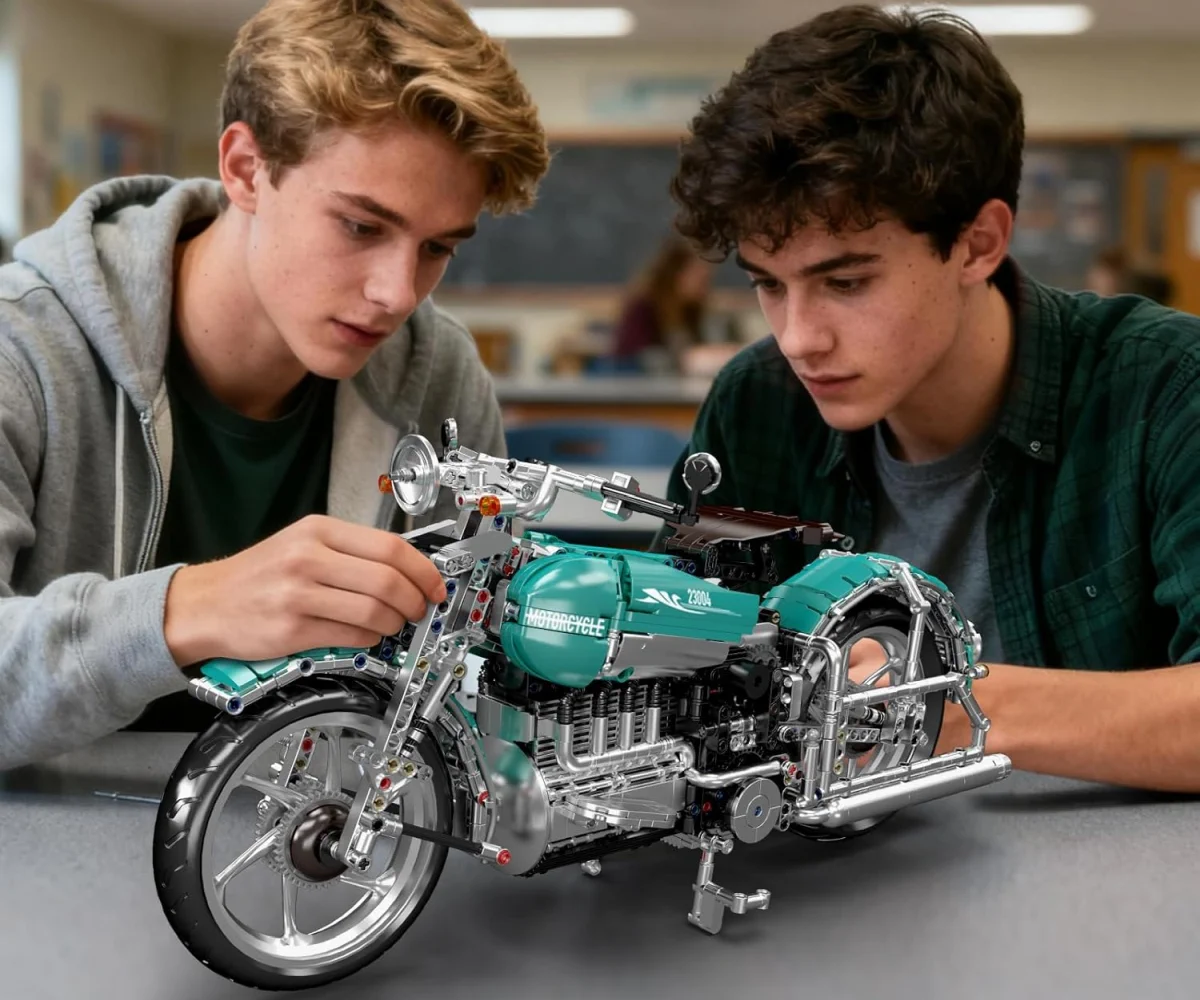 Two young men leaning over the assembled model of a turquoise motorcycle made from blocks on a grey table