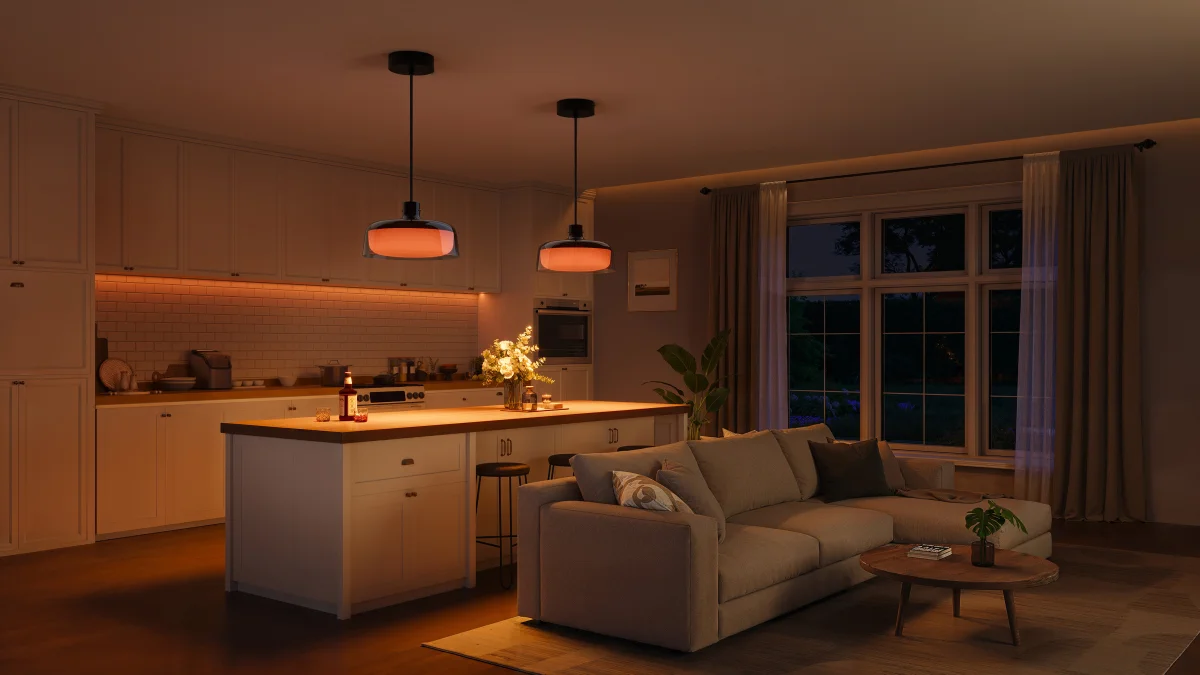 Living room with kitchen lit by warm, atmospheric light from two black H60C1 pendant lights and an LED strip