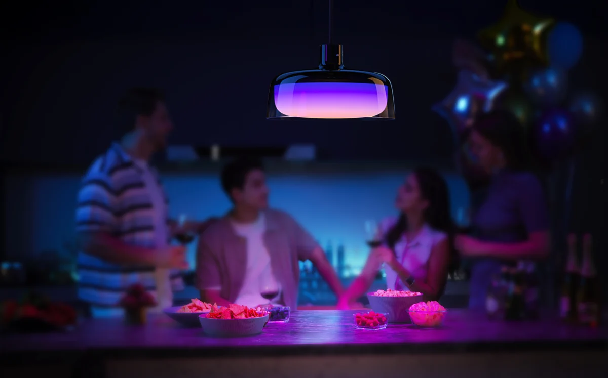 House party with purple accent lighting and a Govee H60C1 pendant lamp above a counter with snacks