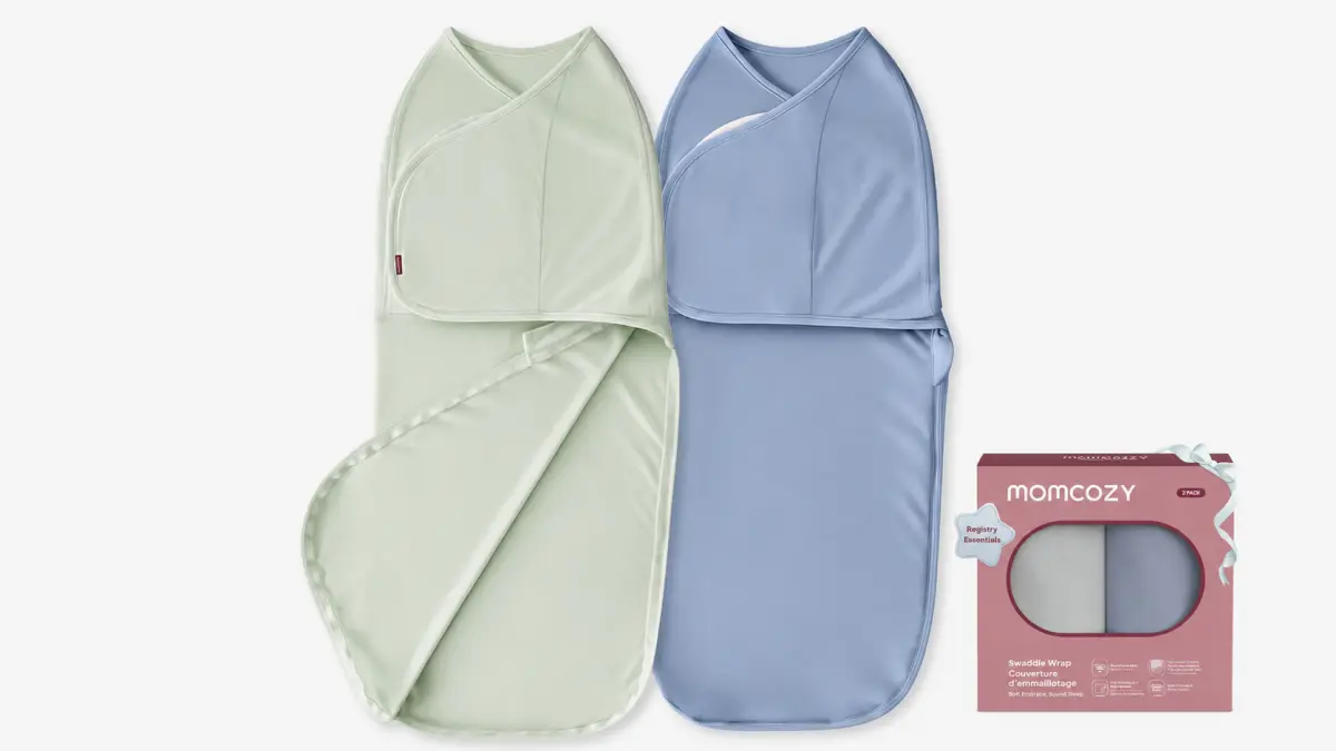 Two baby swaddles in light green and blue next to Momcozy packaging