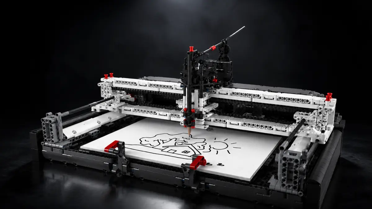 Černo-bílý model plotru z kostek na tmavém studiovém pozadí.