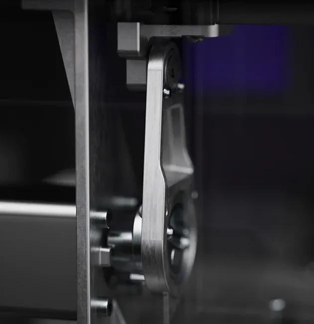 Zbliżenie na metalowy, ruchomy mechanizm ramienia wewnątrz drukarki 3D