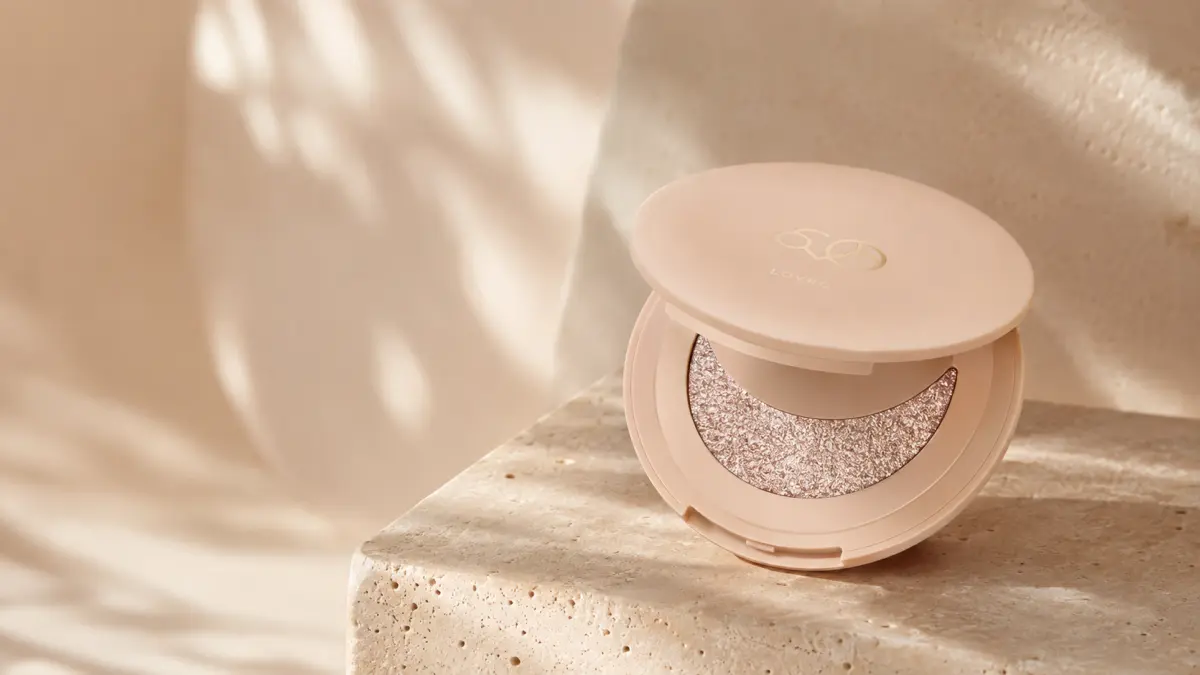 Открытый хайлайтер LOVRO Wet Glow на каменном постаменте в теплом свете